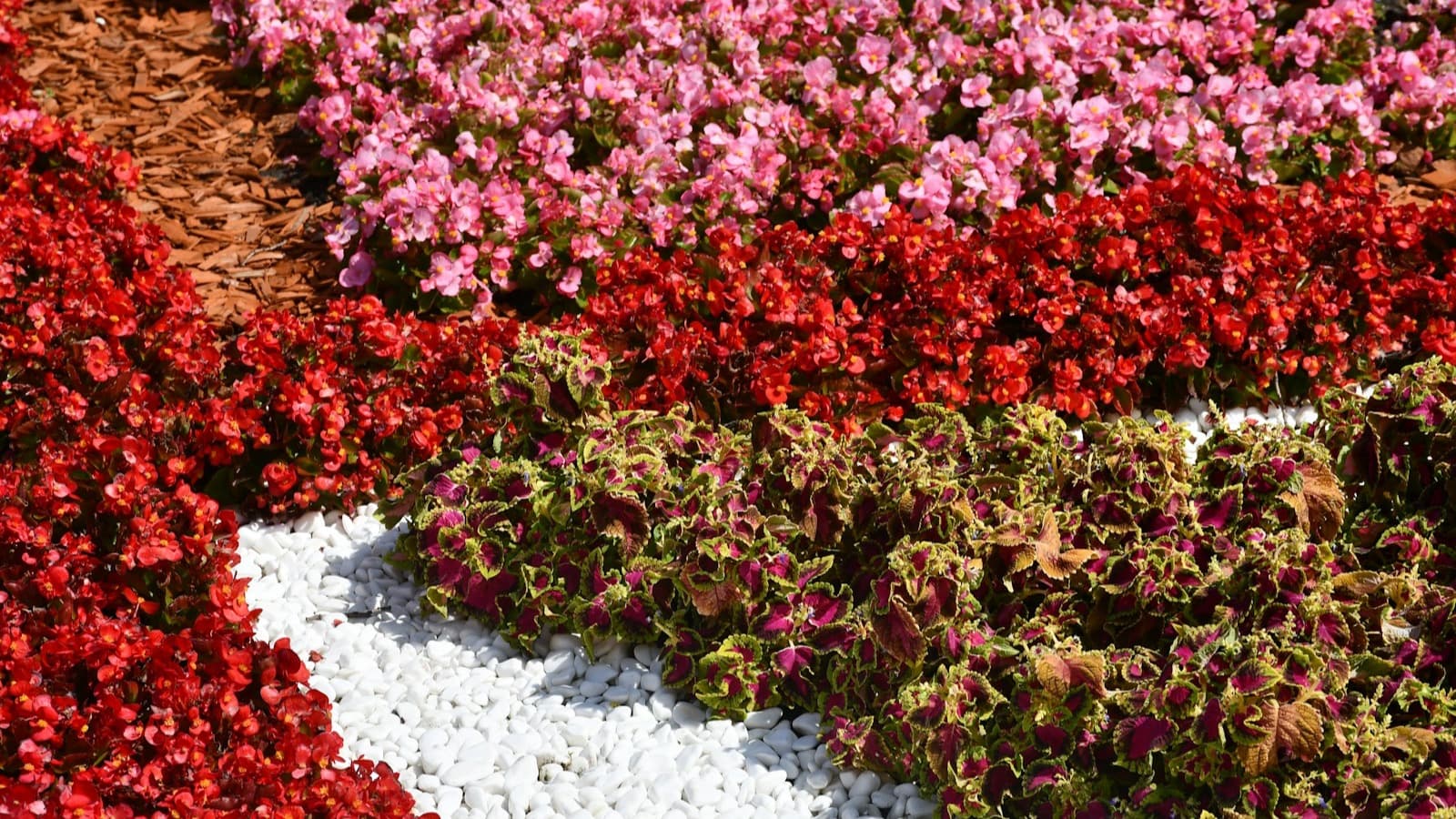 Fresh mulch and decorative beds around seasonal flowers